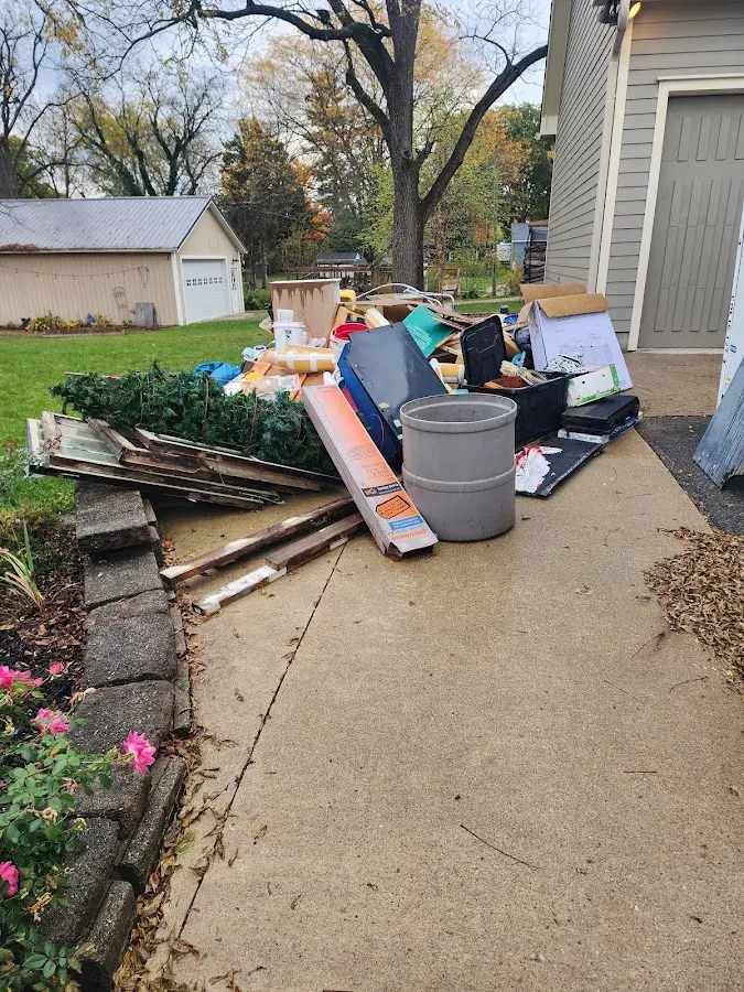 Dumpster being loaded with debris for Roofing Dumpster Rental in Sault Ste. Marie